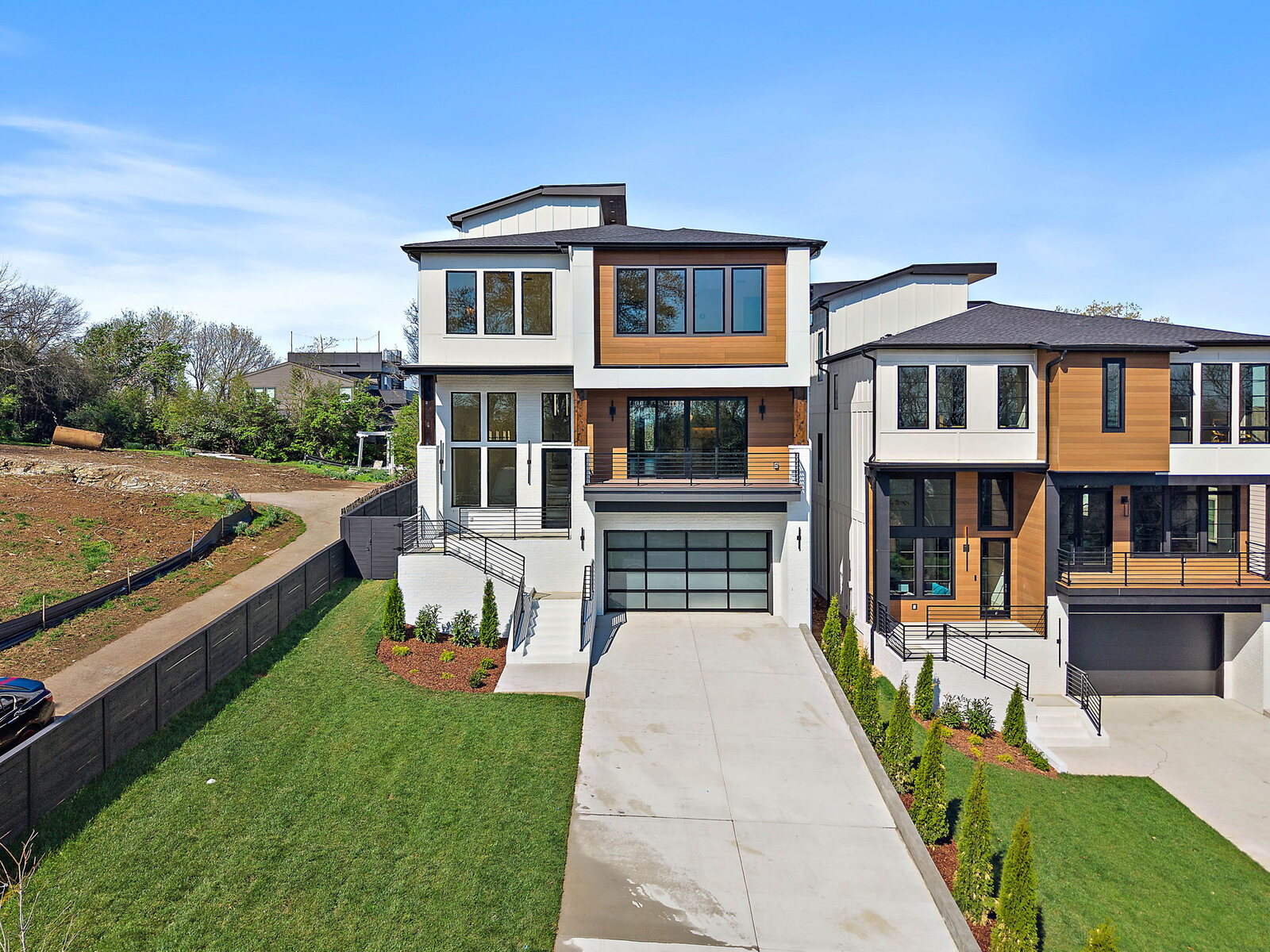 Modern contemporary front elevation with black gable, cedar accents, and clean horizontal massing — Mark Lynn Design, Nashville