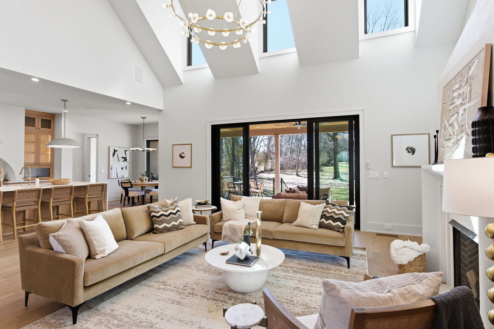 Vaulted great room with stone fireplace and warm staging in a Mark Lynn Design transitional farmhouse, Nashville