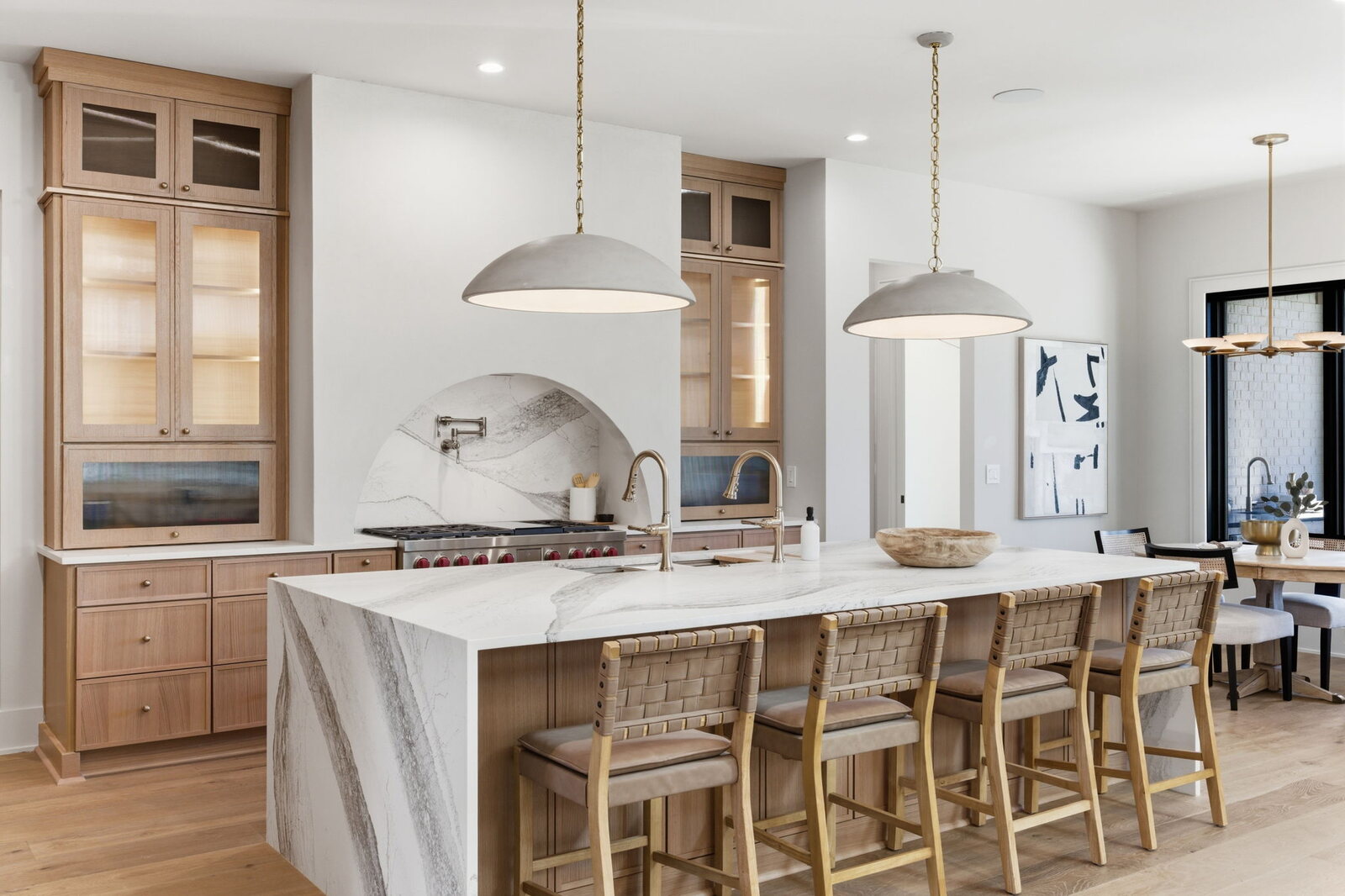 Large white and wood island kitchen with custom range hood in a Mark Lynn Design home, Middle Tennessee