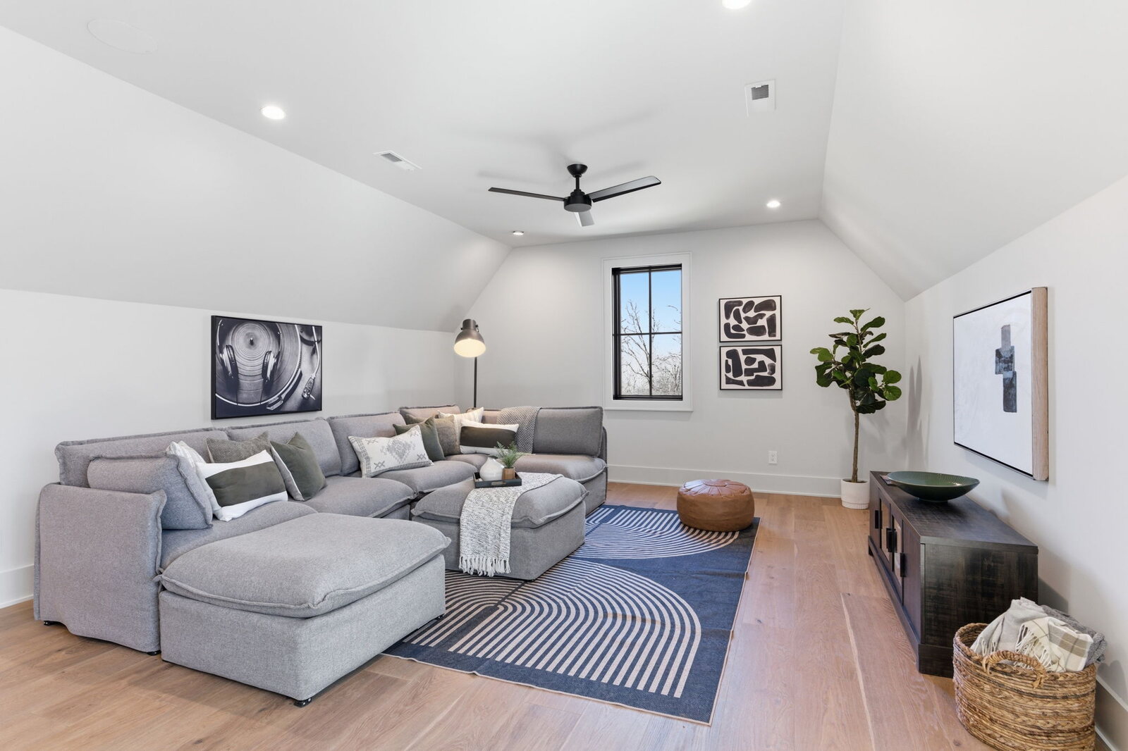 Moody media room with dark walls and fireplace in a Mark Lynn Design Nashville home