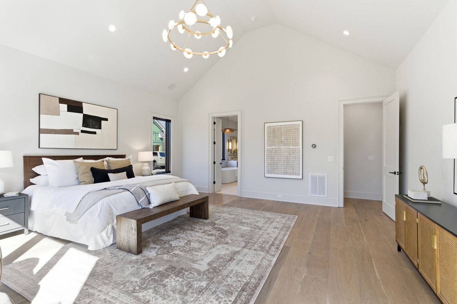 Vaulted primary bedroom with warm staging in a Mark Lynn Design custom home, Nashville