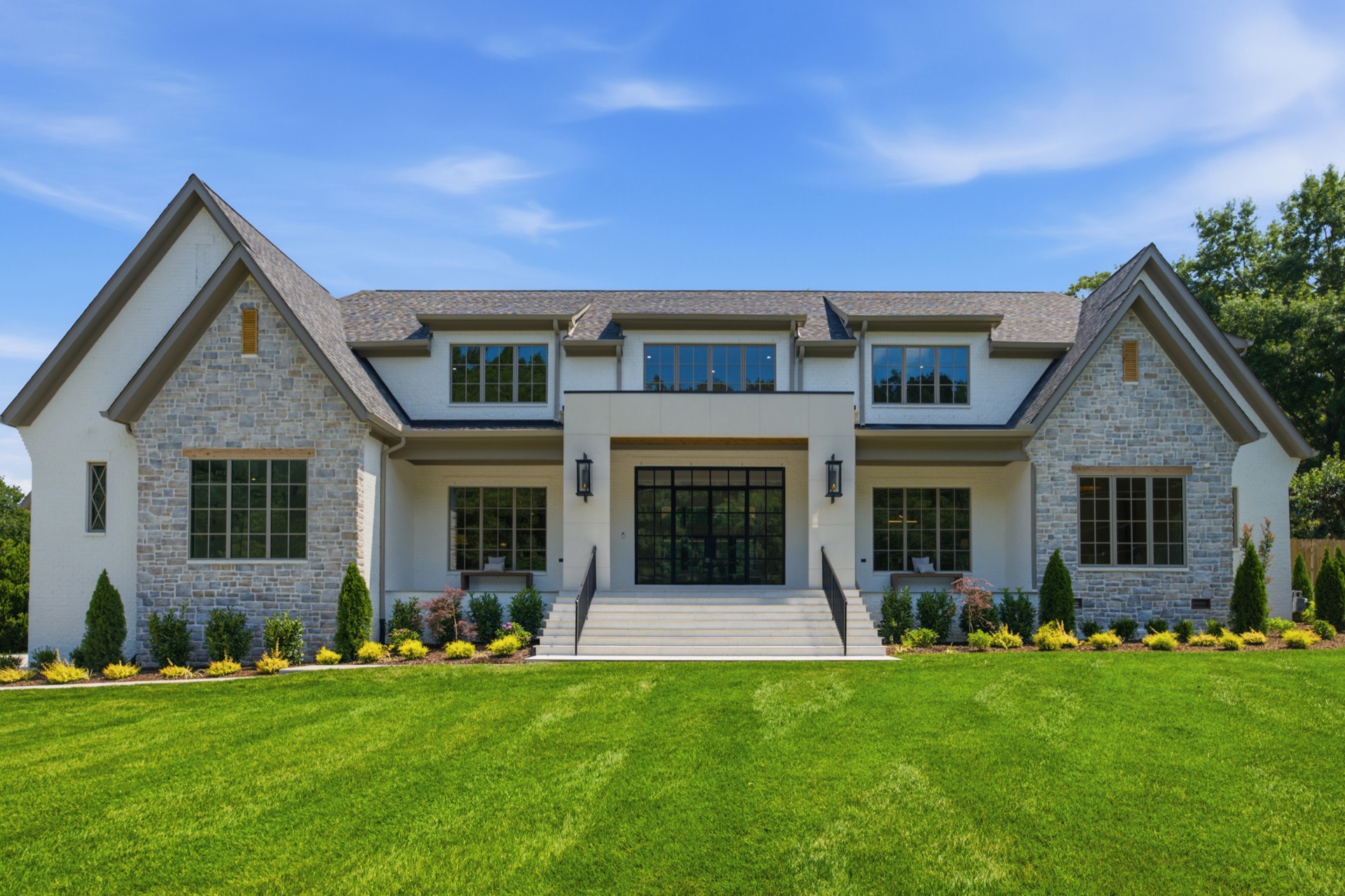 White brick and stone front elevation with steel-frame glass entry, custom home in Nashville — Mark Lynn Design, built by Broadway Builders
